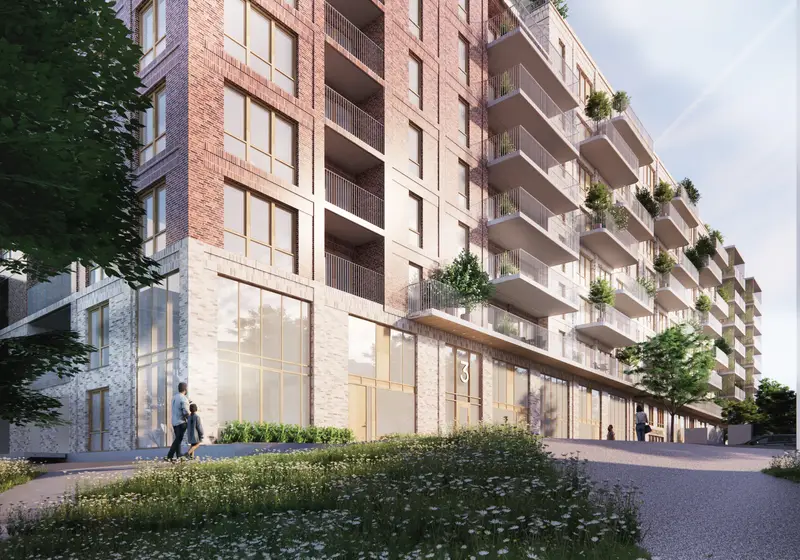 Facade of a modern green apartment building with balconies in Gothenburg, Sweden.